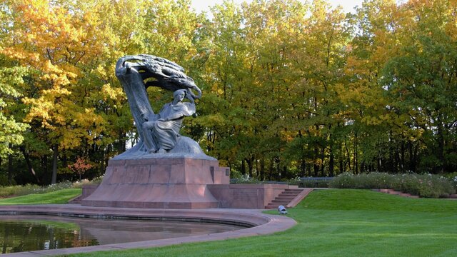 Warsaw, Poland. Frederic Chopin monument. Large, bronze statue of Frederic Chopin located  in the upper part of Warsaw's Royal Baths. Autumn time