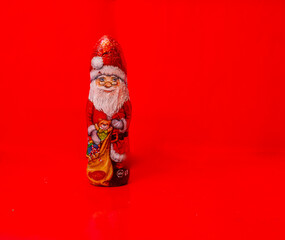 Chocolate christmas santa in a red background