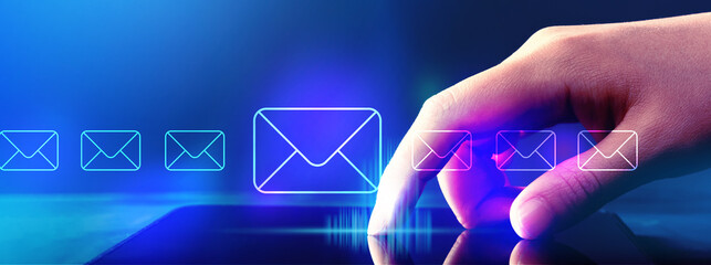 Email concept with hand pressing tablet computer screen