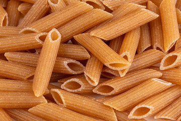 heap of striated penne wholemeal pasta
