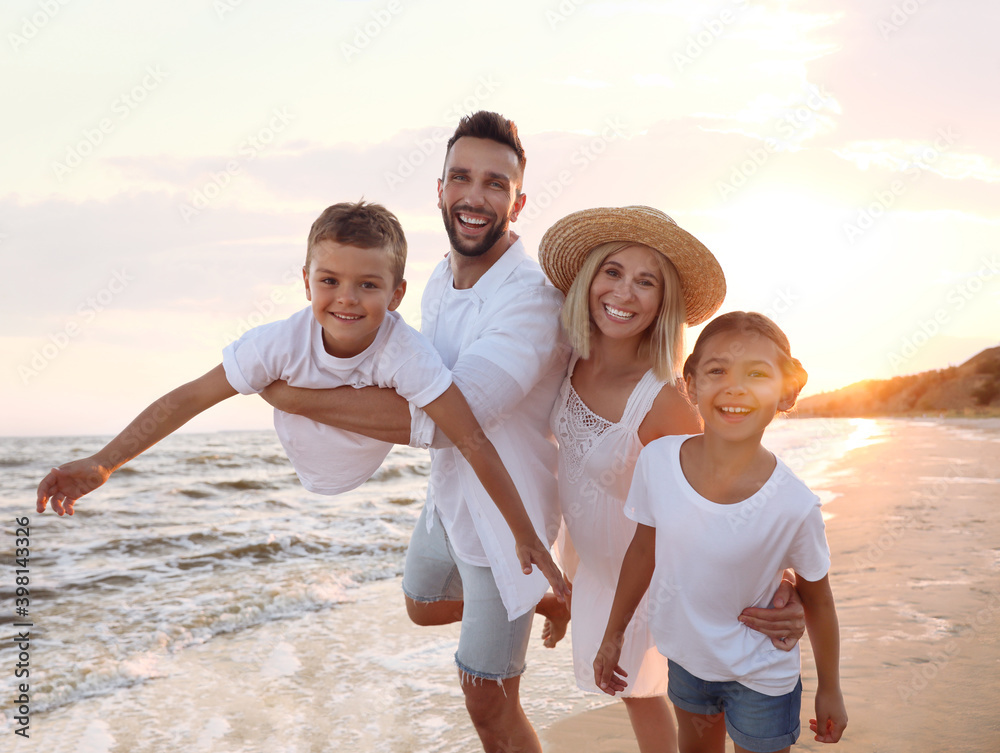 Sticker happy family having fun on sandy beach near sea at sunset