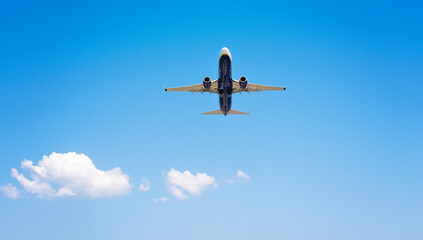 Small plane flying in the clouds on a beautiful sunny day
