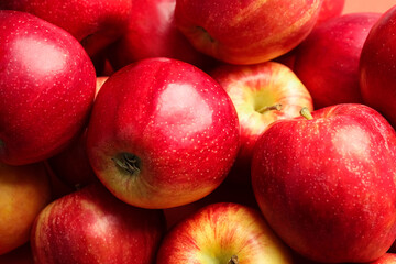 Fototapeta na wymiar Pile of ripe red apples as background, closeup