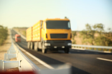 Fototapeta na wymiar Blurred view of asphalt highway with truck. Road trip