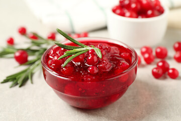 Cranberry sauce, rosemary and fresh berries on light table