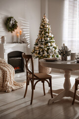 Festive table setting and beautiful Christmas decor in living room. Interior design