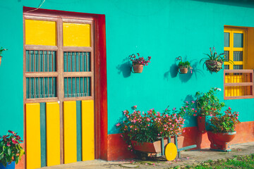 Traditional Colombian house very colorful and with plants outside