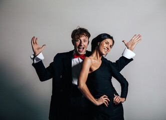 Crazy funny celebration of joyful couple in love in luxury evening clothes having fun together