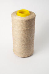 bobbin of yarn on a white background. Side view.Textile reel on isolated white back.