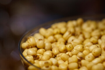 Yellow bean seed in a transparent bowl with blur background