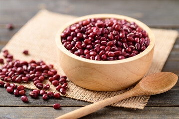Azuki beans or red mung beans in a bowl and spoon on wooden table