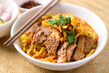 Northern Thai food (Khao Soi), Spicy curry noodles soup with beef eating with pickled mustard, shallot, lime and ground chili fried in oil