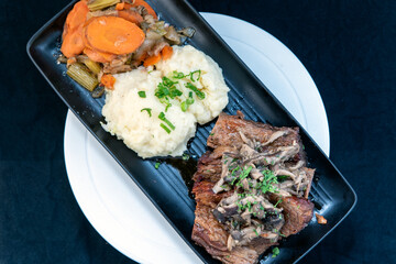 Overhead view of delicious braised beef with mushroom ragu makes the mouth water and the stomach growl.