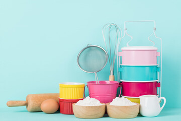 Kitchen utensils and food ingredients for bakery cooking on color background
