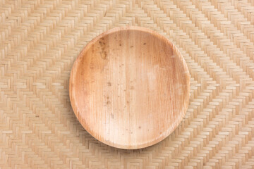 Betel palm leaf plate (Biodegradable, Compostable or Eco friendly disposable plate) on woven bamboo background