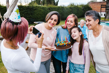 Mexican family celebrating daughter in a birthday party in Mexico city taking a photo selfie