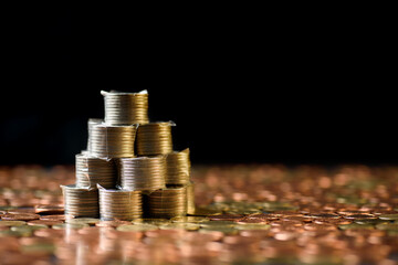 Concepts of finance, investing in assets with interest, dividend and profit. Stacked coins showing...