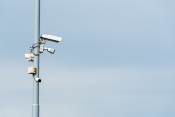 Security cctv cameras on a pole with blue sky background cloudy