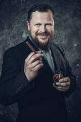 Solid confident bearded man in suit with glass of whisky and cigar