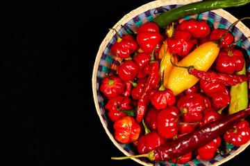 Red hot chilli peppers on black background