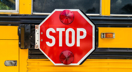 Stop sign on the back of school bus