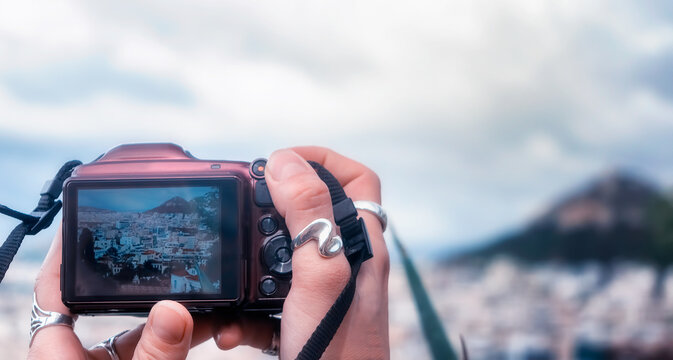 Female hands taking a photo of Athens with a digital camera