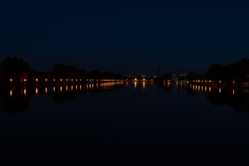 Fototapeta premium Calm water reflections nighttime on a canal in Plovdiv, Bulgaria