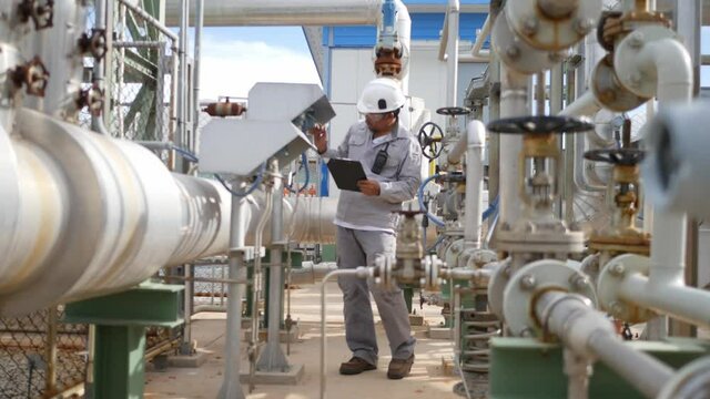 Technicians in the factory on a daily basis and recorded in documents for inspection on the clipboard, Petroleum Oil and refinery concept,
