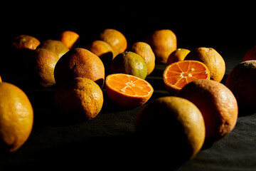 Lemon tangerine on a table black background