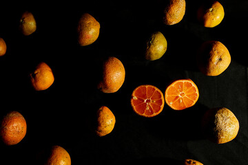 Lemon tangerine on a table black background