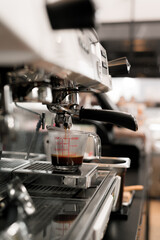 black coffee in measuring cup put on coffee maker