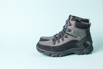 Insulated men's stylish walking shoes for travel on a blue background.