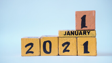 Wooden block calendar with a focus on January 1, 2021. White background