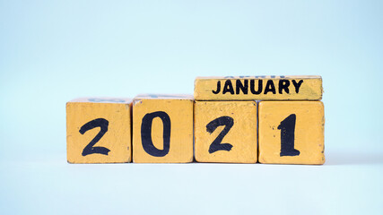 Wooden block calendar with a focus on January 2021. White background