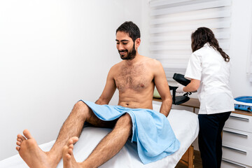 Obraz premium Man in Stretcher in Physiotherapy Clinic