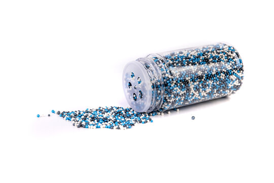 White blue and black sprinkles spilled from a container isolated over white background