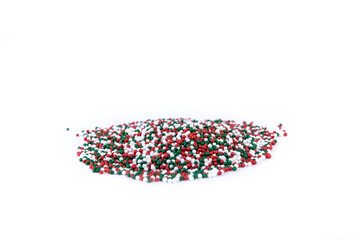 Pile of Red white and green colored candy sprinkles side view