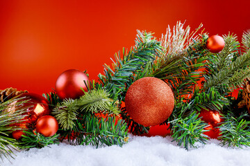 Christmas decoration with snow on abstract red background