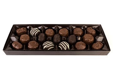 Square box of milk and dark striped chocolates in a shiny brown display