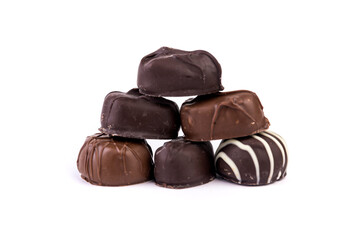 Molded filled chocolates stacked in  a pyramid isolated over white