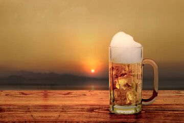 The glass of cold beer on the table