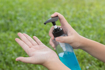 The hand is pressing the alcohol gel to prevent the Covid-19 virus.