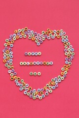 Valentine's Day holiday.Love and relationship concept. Valentine's day inscription from small multicolored letters on bright fuchsia background.Holiday February 14