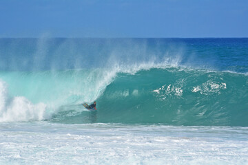 Obraz premium Bodyboarder on the Northshore of Oahu during large winter wave swells in Hawaii, USA. 