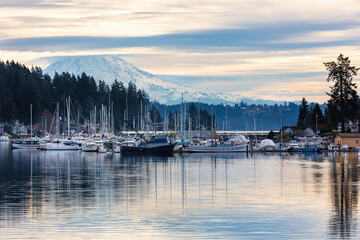 Fototapeta na wymiar Marina in Gig Harbor with boats in the harbor with dramatic clouds and mt rainier 