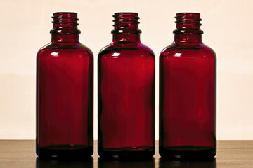 Three empty green glass bottles for women's cosmetics spray. Traditional cosmetics and healthcare