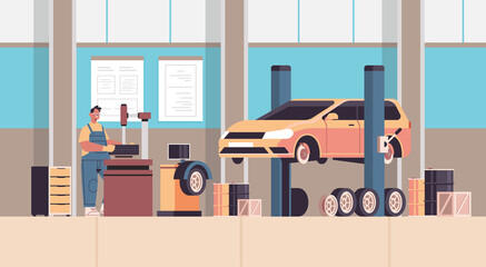 mechanic in uniform repairing tire man working and fixing wheel car service automobile repair and check up concept maintenance station interior horizontal full length vector illustration