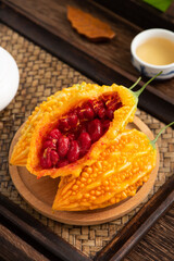 Fresh Fruit momordica charantia on the background of retro Chinese style Tea Plate