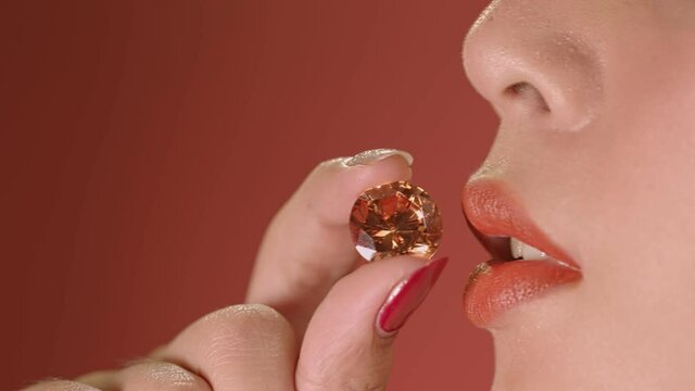 .A smile of lady when she Hold the Citrine Yellow diamond close to the lips