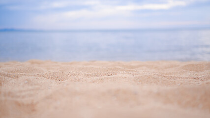 Fototapeta na wymiar Sand beach at coast with blur blue sea and blur sky. travel summer holidays concept.